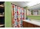 Bathroom includes sink, mirror, and decorative shower curtain on a shower tub combo at 827 Louise St, Brandon, FL 33511