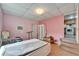 Bedroom featuring a pink painted walls and wood-look tile flooring and exterior access at 827 Louise St, Brandon, FL 33511