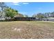 Single-story home featuring a screened-in porch, a well-maintained front yard, and a serene setting at 827 Louise St, Brandon, FL 33511