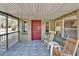 Inviting front porch with rocking chairs, a red door, and natural light at 827 Louise St, Brandon, FL 33511