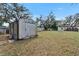 Backyard shed with ample storage space and mature trees at 827 Louise St, Brandon, FL 33511