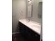 Bathroom features a dual vanity with and sinks and dark cabinets at 832 S Parsons Ave, Brandon, FL 33511