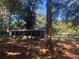 Angle view of home featuring a screened in porch and mature trees at 832 S Parsons Ave, Brandon, FL 33511