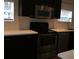 Modern kitchen featuring sleek stainless steel appliances and stylish black cabinetry at 832 S Parsons Ave, Brandon, FL 33511
