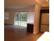 Open living room area with sliding glass door leading to large backyard and updated floors at 832 S Parsons Ave, Brandon, FL 33511