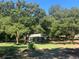 Vacant land surrounded by large, mature trees creates a private setting at 832 S Parsons Ave, Brandon, FL 33511