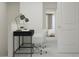 A functional home office space featuring two desks, white chairs, and a neutral color palette at 10241 Trumpet Honeysuckle Way, San Antonio, FL 33576