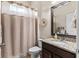 Cozy bathroom featuring a granite vanity, framed mirror, and a shower with a neutral-toned curtain at 1106 Tracey Ann Loop, Seffner, FL 33584