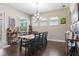 Formal dining area featuring hardwood floors and a decorative chandelier at 1106 Tracey Ann Loop, Seffner, FL 33584