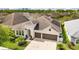 Charming home with a well-manicured lawn, arched entryway, and a three-car garage at 1106 Tracey Ann Loop, Seffner, FL 33584