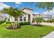 Lush front yard with mature landscaping highlights this charming home with a two-car garage and inviting entrance at 1106 Tracey Ann Loop, Seffner, FL 33584