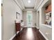 Elegant foyer featuring hardwood floors, decorative molding, and ample natural light at 1106 Tracey Ann Loop, Seffner, FL 33584