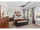 This primary bedroom has a tray ceiling, ceiling fan, and lots of natural light at 1106 Tracey Ann Loop, Seffner, FL 33584