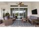 Relaxing covered patio with wicker furniture, ceiling fan, and view of the pool at 1106 Tracey Ann Loop, Seffner, FL 33584