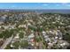 Aerial view of a neighborhood with a home, featuring lush trees and a glimpse of the bay at 115 21St Ne Ave, St Petersburg, FL 33704
