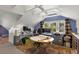 Finished attic office with a sloped ceiling, bright blue wall, and windows overlooking trees at 115 21St Ne Ave, St Petersburg, FL 33704