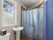 Bathroom with a pedestal sink and shower with a frosted window for natural light at 115 21St Ne Ave, St Petersburg, FL 33704