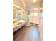 Modern bathroom features a glass shower, vessel sink, and sleek, earth-toned tile flooring at 115 21St Ne Ave, St Petersburg, FL 33704