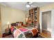 Bedroom with colorful bedding and a ceiling fan, complemented by built-in shelving for storage at 115 21St Ne Ave, St Petersburg, FL 33704