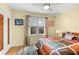 Comfortable bedroom features a ceiling fan, a window with natural light, and hardwood floors at 115 21St Ne Ave, St Petersburg, FL 33704