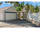 Detached garage and driveway with gravel and a gated entrance to the home at 115 21St Ne Ave, St Petersburg, FL 33704