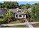 Charming home with lush landscaping, a well-manicured lawn, and a welcoming front entrance at 115 21St Ne Ave, St Petersburg, FL 33704
