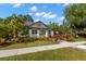 Charming single-story home with lush landscaping, mature trees, and inviting curb appeal at 115 21St Ne Ave, St Petersburg, FL 33704