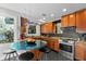 Bright kitchen with stainless steel appliances, wooden cabinets, and a glass topped breakfast bar at 115 21St Ne Ave, St Petersburg, FL 33704