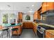 Well-lit kitchen with stainless steel appliances, wooden cabinets, granite countertops, and breakfast bar at 115 21St Ne Ave, St Petersburg, FL 33704