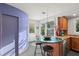 Kitchen featuring granite countertops, wooden cabinets, a breakfast bar, and a rear door at 115 21St Ne Ave, St Petersburg, FL 33704