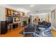 Bright living room with hardwood floors, brick fireplace, and open floor plan to the dining area at 115 21St Ne Ave, St Petersburg, FL 33704