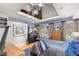 Bright main bedroom with a vaulted ceiling, loft, and windows overlooking the wooded yard at 115 21St Ne Ave, St Petersburg, FL 33704