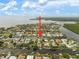 Aerial view showcasing waterfront property with canal access and dock, highlighted with a directional arrow at 121 Colonial Sw St, Port Charlotte, FL 33952
