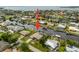 Aerial view with an arrow pointing to a waterfront home with a private dock, surrounded by lush landscaping and canal views at 121 Colonial Sw St, Port Charlotte, FL 33952