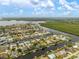 Gorgeous aerial view of waterfront community with canals providing boating access and stunning natural backdrop at 121 Colonial Sw St, Port Charlotte, FL 33952