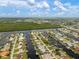 Breathtaking aerial view of waterfront homes with private docks and scenic views of the surrounding water and landscape at 121 Colonial Sw St, Port Charlotte, FL 33952