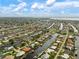 Aerial view showcasing waterfront homes in a canal community, each with private docks and easy access to the bay and gulf at 121 Colonial Sw St, Port Charlotte, FL 33952