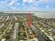 An aerial view with an arrow pointing to a charming waterfront home with a private dock in a canal community with direct Gulf access at 121 Colonial Sw St, Port Charlotte, FL 33952