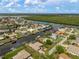 Stunning aerial view of waterfront homes with private boat docks on canals, surrounded by lush greenery at 121 Colonial Sw St, Port Charlotte, FL 33952