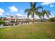 Lush backyard with mature palm trees and a canal offering boating opportunities at 121 Colonial Sw St, Port Charlotte, FL 33952