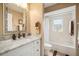 Bathroom showcasing a vanity, framed mirror, and a tiled shower/tub combo with a window at 121 Colonial Sw St, Port Charlotte, FL 33952