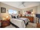 Bedroom featuring a bed, wooden furniture, and a window providing natural light with a ceiling fan at 121 Colonial Sw St, Port Charlotte, FL 33952