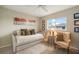 Cozy bedroom displaying a daybed, accent chair, and decorative wall art with a ceiling fan at 121 Colonial Sw St, Port Charlotte, FL 33952