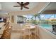 Cozy breakfast nook features a white table and chairs, offering views of the lanai and pool at 121 Colonial Sw St, Port Charlotte, FL 33952