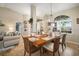 Dining room featuring a wooden table, chairs, decor, and bright lighting with a view to the Living Room at 121 Colonial Sw St, Port Charlotte, FL 33952