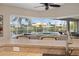 Kitchen bar overlooking screened-in lanai with pool view at 121 Colonial Sw St, Port Charlotte, FL 33952