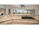 Kitchen bar overlooking screened-in lanai with canal view at 121 Colonial Sw St, Port Charlotte, FL 33952