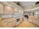 Open concept kitchen with modern appliances and seamless connection to the living areas at 121 Colonial Sw St, Port Charlotte, FL 33952