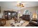 Relaxing living room with a large entertainment center, comfortable leather seating, and natural light at 121 Colonial Sw St, Port Charlotte, FL 33952