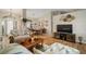 Spacious living room showcasing wood-look floors, natural light, and views of the dining area at 121 Colonial Sw St, Port Charlotte, FL 33952